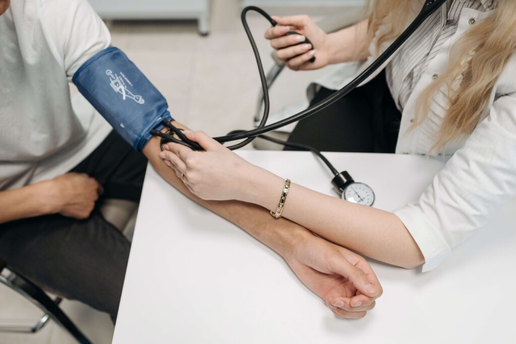 A doctor checking a patient's blood pressure.