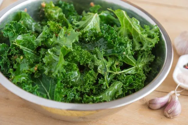 The picture shows some kale in a bowl. Do you know about the probable side effects of eating kale everyday?